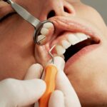 dental exam with mirror and tool