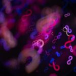 Abstract infinity symbols in neon pink and blue lights.