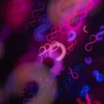Abstract infinity symbols in neon pink and blue lights.